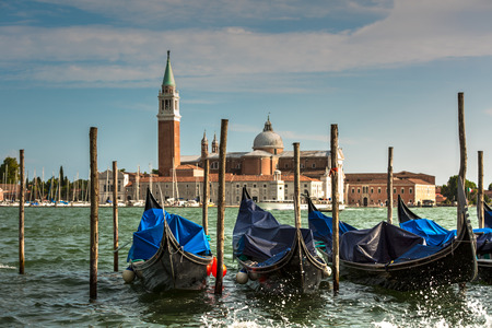 A view of famous Traditional Venice gondolas parking on grand canal and Piazza San Marco Squareの写真素材
