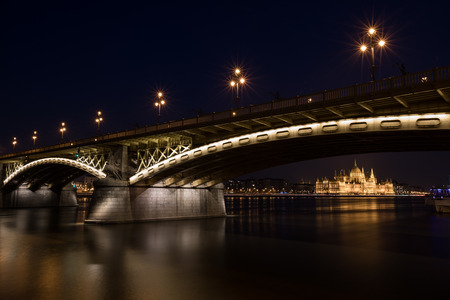 A night view of Margaret bridge over the Danube and famous historical Parliament building at dusk in Budapest Hungaryの写真素材