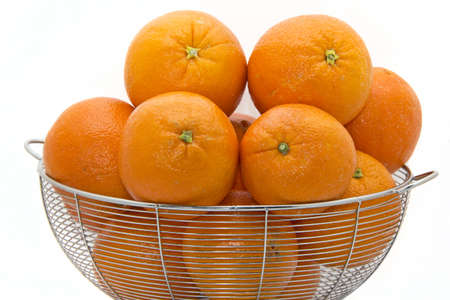 Delicious ripe Florida oranges stacked up on a white plateの写真素材