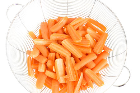 baby carrots split in half ready to be cookedの写真素材