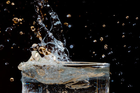 Water splashing in a glass of waterの写真素材