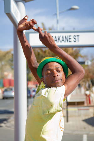 Soweto, South Africa- July 29 - A street performer demonstrates several acrobatic moves showing his body?s unbelievable flexibility near  Mandela's house on July 29, 2012 in Soweto, South Africaのeditorial素材