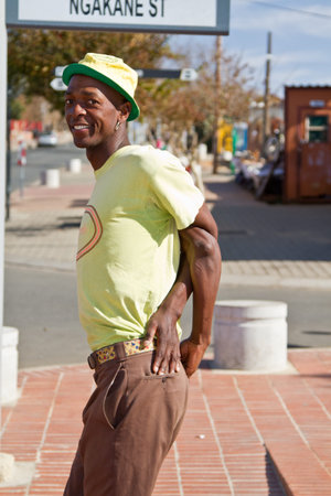 Soweto, South Africa? July 29 ? A street performer demonstrates several acrobatic moves showing his...
