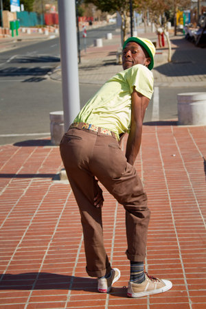 Soweto, South Africa- July 29 - A street performer demonstrates several acrobatic moves showing his body?s unbelievable flexibility near  Mandela's house on July 29, 2012 in Soweto, South Africaのeditorial素材