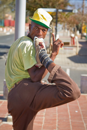 Soweto, South Africa- July 29 - A street performer demonstrates several acrobatic moves showing his body?s unbelievable flexibility near  Mandela's house on July 29, 2012 in Soweto, South Africaのeditorial素材