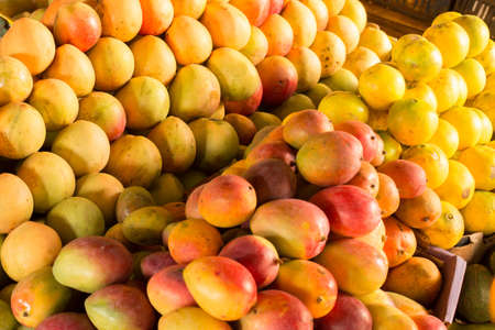 Ripe mangoes stacked at a local fruit and vegetable market in Kenya, Nairobiの写真素材