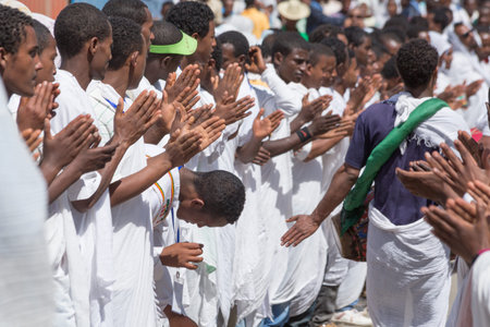 ADDIS ABABA, ETHIOPIAâ JANUARY 19: Young members of the clergy clap their hands and sing religious songs while accompanying the Tabot, a model of the arc of covenant, during a colorful procession which is part of Timket celebrations of Epiphany, commemoのeditorial素材