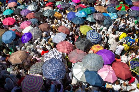 ADDIS ABABA, ETHIOPIAâ JANUARY 20: A large crowd of people with colorful umbrella accompany the Tabot, a model of the arc of covenant, during a colorful procession which is part of Timket celebrations of Epiphany, commemorating the baptism of Jesus in tのeditorial素材