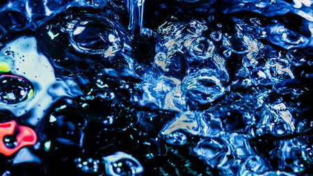 Fluid motion of splashing water and bubbles forming abstract alien bfigures