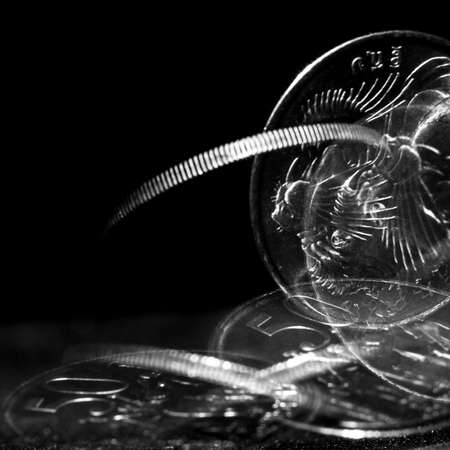 Stroboscopic effect created using flash capturing the motion of a coin as it is spinningの写真素材