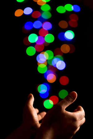 Catching beautiful light bokeh bubbles created by out of focus colorful lightsの写真素材