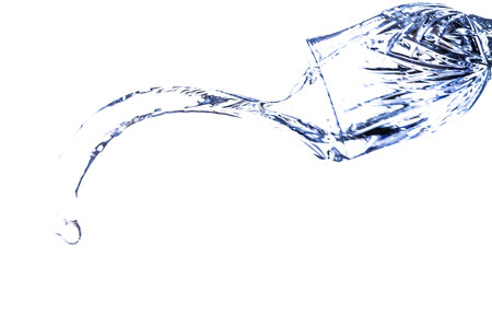 A beautiful shape created by the fluid motion of water splashing as it is thrown out of a glass