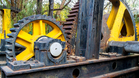 The grooves of two big and old rusted gears lined up into placeの写真素材