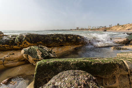 The beautiful waters of the Atlantic ocean with its rocky coastline near the City of Dakar in Senegalの写真素材