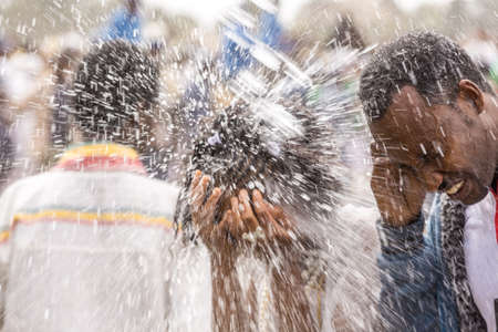 Holy water is sprayed onto the crowd attending Timket celebrations of Epiphany, commemorating the baptism of Jesus, on January 19, 2014 in Addis Ababa.のeditorial素材