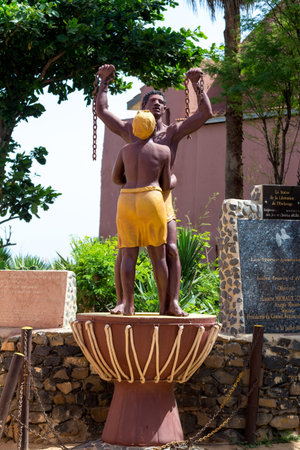 A statue of a slave breaking his chains, and woman hugging him is erected on GorÃ©e Island to...