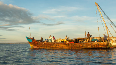 An old wooden sailboat carrying tourists near the shores of Dar es Salaam, Tanzania