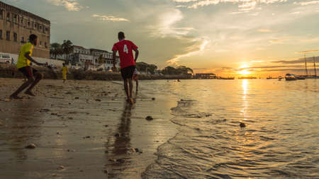 Kids playing football on the beach during a beautiful sunset, Zanzibar, Tanzaniaのeditorial素材
