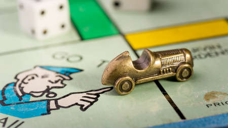The racecar monopoly piece landing on go to jail space of a monopoly boardのeditorial素材
