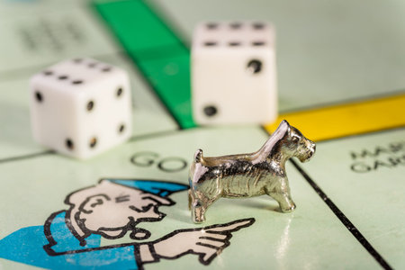 The Scottie dog monopoly piece landing on go to jail space of a monopoly board