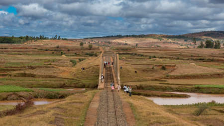 Malagasy people from the countryside cross a railroad bridge on the way to work and school on May 25, 2014 in Madagascar のeditorial素材