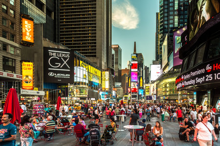 New York - Sept 2014: Tourists relax and enjoy the view of the busy streets of 42nd Street, Times Square on Sept 7, 2014 in New York, USA.のeditorial素材