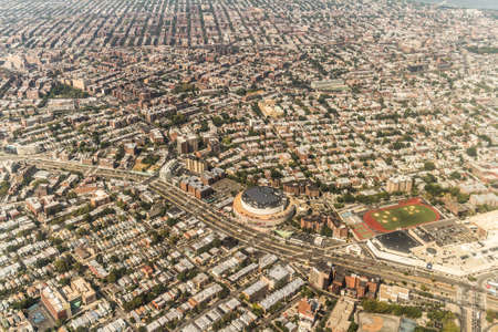 Aerial view of the Borough of Queens, New York, showing densely packed buildings and a multi-lane super highwayの写真素材