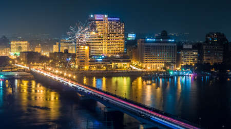 Aerial view of the city of Cairo along the Nile river at night with fireworks in the backgroundのeditorial素材