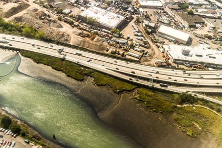 Aerial view of the Borough of Queens, New York, showing densely packed buildings and a multi-lane super highwayの写真素材