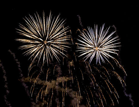 A close-up shot of sparkling Fireworks bursting out into beautiful shapesの写真素材