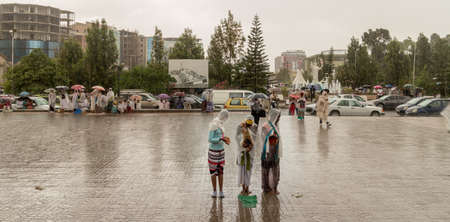 Addis Ababa: April 10: Devoted Ethiopian Orthodox followers stand undeterred by the pouring rain to observe Siklet, the crucifixion of Jesus Christ, at Bole Medhane Alem Church on April 10 ,2015 in Addis Ababa, Ethiopiaのeditorial素材