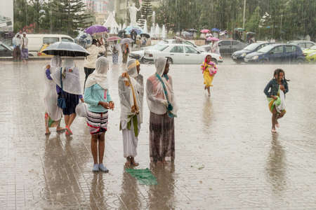 Addis Ababa: April 10: Devoted Ethiopian Orthodox followers stand undeterred by the pouring rain to observe Siklet, the crucifixion of Jesus Christ, at Bole Medhane Alem Church on April 10 ,2015 in Addis Ababa, Ethiopiaのeditorial素材