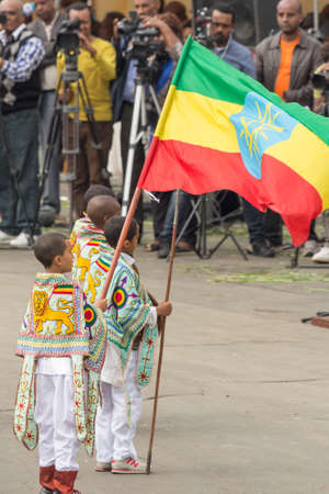 Addis Ababa  May 5: A young boy dressed in colourful traditional outfit holds the Ethiopian flag at the 74th anniversary of Patriots' Victory day commemorating the defeat of the invading Italians on May 5 2015 in Addis Ababa Ethiopia.のeditorial素材