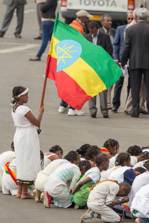 Addis Ababa  May 5: A young girl dressed in colourful traditional outfit holds the Ethiopian flag at the 74th anniversary of Patriots' Victory day commemorating the defeat of the invading Italians on May 5 2015 in Addis Ababa Ethiopia.のeditorial素材