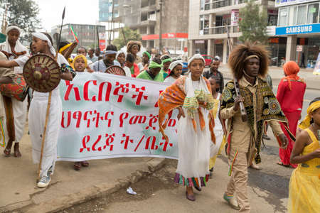 Addis Ababa  May 5: Young men and women dressed in colourful traditional outfit march on the streets of Addis Ababa during the 74th anniversary of Patriots' Victory day commemorating the defeat of the invading Italians on May 5 2015 in Addis Ababa Ethiopiのeditorial素材