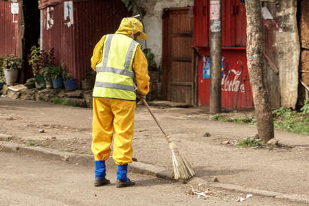 Addis Ababa - July 26: A member of the city cleaning crew sweeps the streets with a broom on July 26, 2015 in Addis Ababa, Ethiopia.のeditorial素材