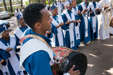ADDIS ABABA, ETHIOPIA - May 21: A young member of the Ethiopian Orthodox Church Choir sing and chant accompanied by a drum during a colorful procession on May 21, 2016 in Addis Ababa, Ethiopiaのeditorial素材