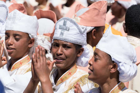 Addis Ababa - Jan 19: Ethiopian Orthodox Clergy and followers sing and chant while accompanying the Tabot, a model of the arc of covenant, during a colorful procession which is part of Timket celebrations of Epiphany, on JJanuary 19, 2017 in Addis Ababa, のeditorial素材