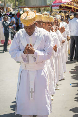 Addis Ababa - Jan 19: Ethiopian Orthodox Clergy and followers sing and chant while accompanying the Tabot, a model of the arc of covenant, during a colorful procession which is part of Timket celebrations of Epiphany, on January 19, 2017 in Addis Ababa, Eのeditorial素材