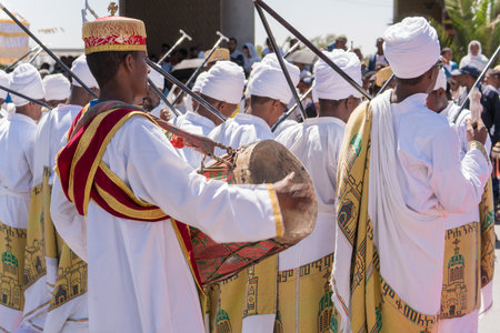 Addis Ababa - Jan 19: Clergy accompany the singing and chanting of Ethiopian Orthodox followers with kebero, a traditional drum made out of animal hide, during Timket celebrations of Epiphany, on January 19, 2017 in Addis Ababa, Ethiopia.のeditorial素材