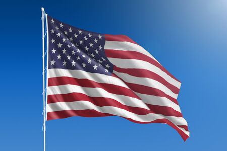 Flag of United States in front of a clear blue skyの写真素材