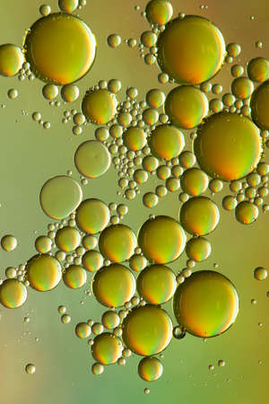 Metallic green and gold oil and water abstractの写真素材