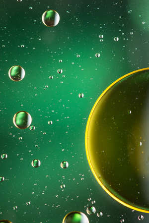 Oil and water abstract in green and goldの写真素材