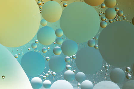 Oil and water abstract in silver, blue and yellowの写真素材