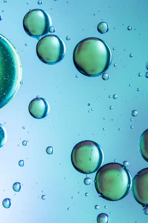 Oil and water abstract in green and blueの写真素材
