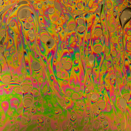 Multicolored soap bubble abstract background formed by light reflecting off the surface of a soap filmの写真素材