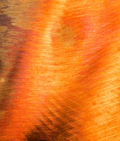 Orange, scratched, grungy steel backgroundの写真素材