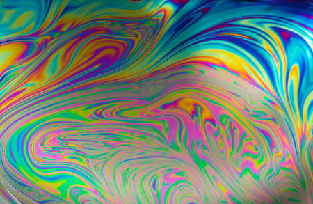 Psychedelic abstract formed by light on the surface of a soap bubbleの写真素材