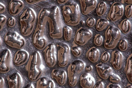 Closeup of a silver metallic surfaceの写真素材