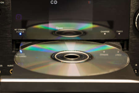 Selective focus cd and its reflection on the surface of a cd playerの写真素材
